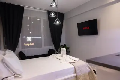 a bedroom with a bed and a window with a tv at AcroView Right In The Center in Athens
