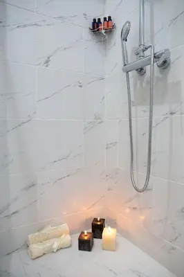 a bathroom with a shower with candles and a candle holder at AcroView Right In The Center in Athens