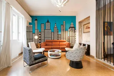 a living room with a couch and a city mural at Mid century 3 bdr city centre townhouse in Athens