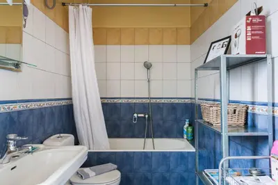 a bathroom with a toilet and a tub and a sink at Mid century 3 bdr city centre townhouse in Athens