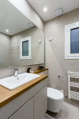 a bathroom with a white sink and a toilet at Serene 1 BR Apartment in Koukaki by UPSTREET in Athens