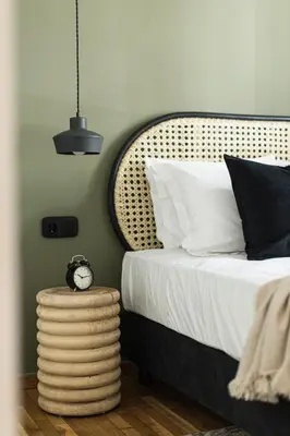 a bedroom with a bed and a clock on a table at Serene 1 BR Apartment in Koukaki by UPSTREET in Athens