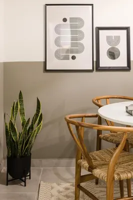 a dining room with a table and chairs and a plant at Serene 1 BR Apartment in Koukaki by UPSTREET in Athens