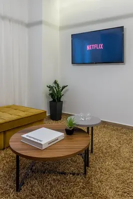 a living room with a table with a laptop on it at The Averof (Kalimarmaro) City Center Apartment in Athens