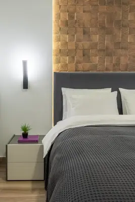 a bedroom with a bed with a wooden headboard at The Averof (Kalimarmaro) City Center Apartment in Athens