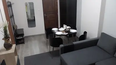 a living room with a table and a couch at Ellada Apartment in Athens