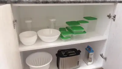 a shelf with bowls and other items in a bathroom at Ellada Apartment in Athens
