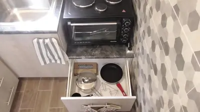 a kitchen with a stove and a toaster oven at Ellada Apartment in Athens
