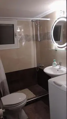 a bathroom with a shower and a toilet and a sink at Ellada Apartment in Athens