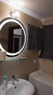 a bathroom with a sink and a mirror and a toilet at Ellada Apartment in Athens