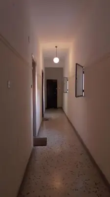 an empty hallway in an empty building with a light on at Ellada Apartment in Athens