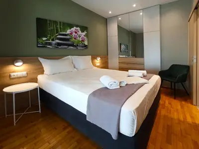 a hotel room with a large bed and a chair at Athens Sweet Home by YHA in Athens