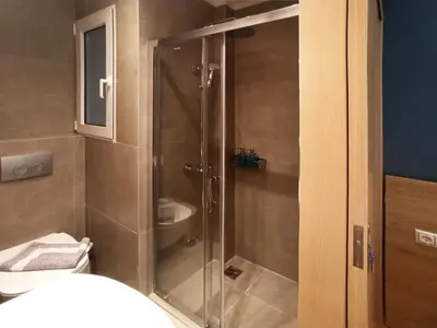 a bathroom with a shower with a toilet and a sink at Athens Sweet Home by YHA in Athens