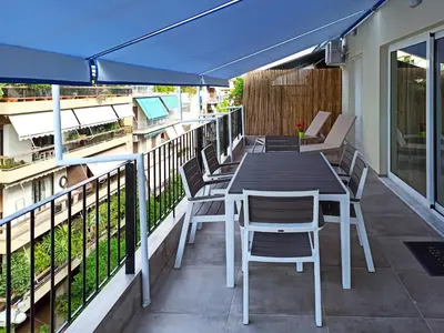 a patio with a table and chairs and an umbrella at Athens Sweet Home by YHA in Athens