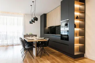 a kitchen with a table and black cabinets at 5BD 2 Level Beachfront Luxury Apt by the Olon in Athens