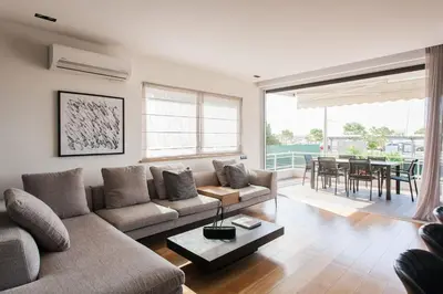 a living room with a couch and a table at 5BD 2 Level Beachfront Luxury Apt by the Olon in Athens