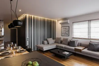 a living room with a couch and a table at 5BD 2 Level Beachfront Luxury Apt by the Olon in Athens