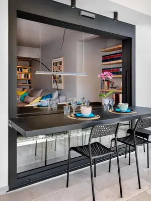 a dining room with a black table and chairs at Central Athens Penthouse in Athens