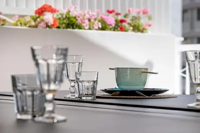 a table with glasses and a cup and a plate at Central Athens Penthouse in Athens