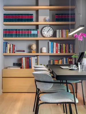 a room with a table with chairs and a clock at Central Athens Penthouse in Athens