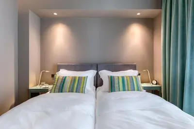 two beds in a bedroom with two pillows at Central Athens Penthouse in Athens