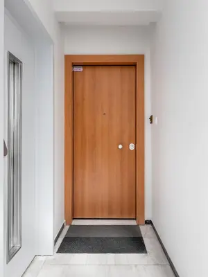 a wooden door in a hallway with a tile floor at Central Athens Penthouse in Athens