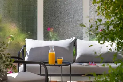 two glasses of orange juice on a table on a couch at Central Athens Penthouse in Athens