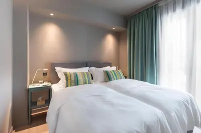 a bedroom with two white beds and a window at Central Athens Penthouse in Athens