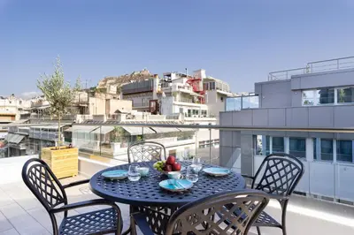 a table with a bowl of fruit on top of a balcony at Hestia - Ippokratous 35 in Athens