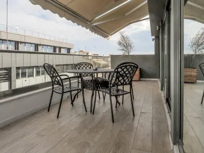 a patio table and chairs on a balcony at Hestia - Ippokratous 35 in Athens