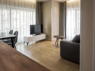a living room with a couch and a tv and a table at Hestia - Ippokratous 35 in Athens