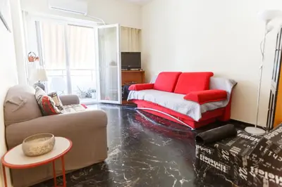 a living room with a couch and a table at Peonios Apartment in Athens