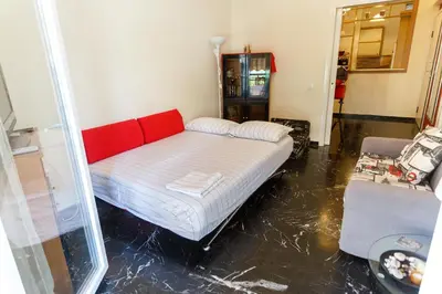 a room with a bed with a red head board at Peonios Apartment in Athens