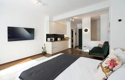 a bedroom with a bed and a living room at Athens' Best Location- Stunning & Spacious Studio in Athens