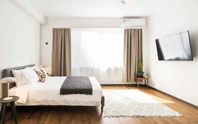 a bedroom with a bed and a large window at Athens' Best Location- Stunning & Spacious Studio in Athens