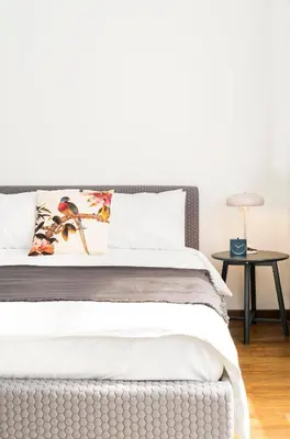 a bedroom with a white bed with a side table at Athens' Best Location- Stunning & Spacious Studio in Athens