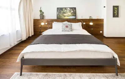 a bedroom with a large bed with a wooden headboard at Athens' Best Location- Unique Magnificent Studio in Athens