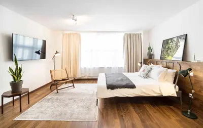 a bedroom with a bed and a chair and a television at Athens' Best Location- Unique Magnificent Studio in Athens
