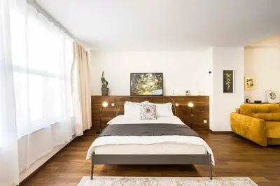 a bedroom with a bed and a yellow chair at Athens' Best Location- Unique Magnificent Studio in Athens