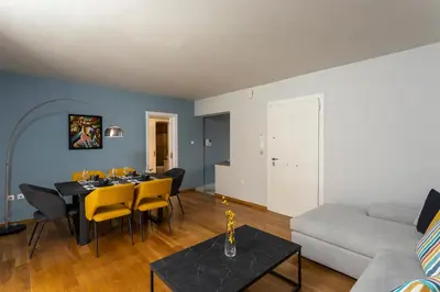 a living room with a table and a couch at AthensBlues Kolonaki 2 Bedroom with Car Park in Athens