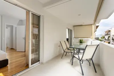a dining room with a table and chairs on a balcony at AthensBlues Kolonaki 2 Bedroom with Car Park in Athens
