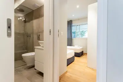 a bathroom with a toilet and a sink and a tub at AthensBlues Kolonaki 2 Bedroom with Car Park in Athens
