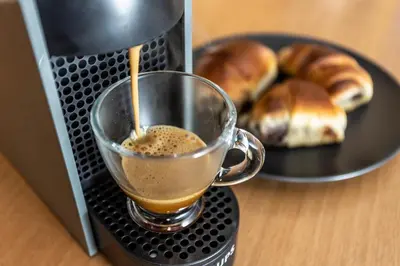 a cup of coffee and a plate of doughnuts at AthensBlues Kolonaki 2 Bedroom with Car Park in Athens