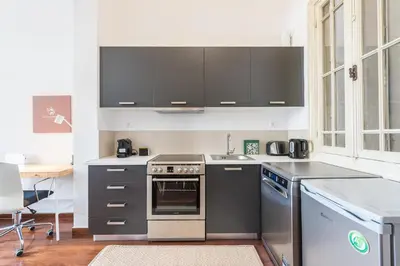 a kitchen with stainless steel appliances and a sink at Mavrogenous - The Mansion in Athens