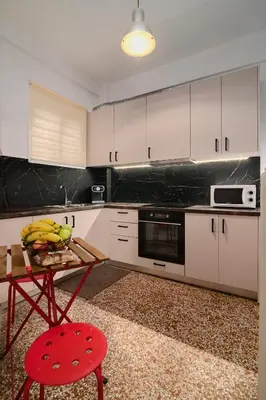 a kitchen with a table with bananas on it at Venias Two-Bedroom apartment Kallimarmaro and Zappeio area in Athens