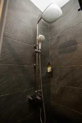 a shower with a shower head in a bathroom at Raise Acropolis View Suites in Athens