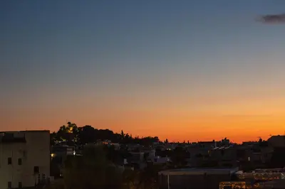 a view of a city at sunset at Raise Acropolis View Suites in Athens