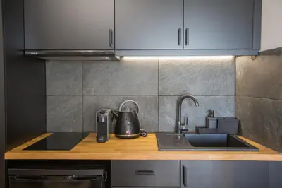 a kitchen with a sink and a tea kettle at Raise Acropolis View Suites in Athens