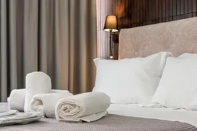a hotel room with a bed with towels on it at Koios Apartments in Athens