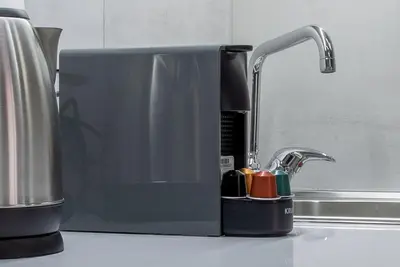 a kitchen counter with a sink with a faucet at Koios Apartments in Athens
